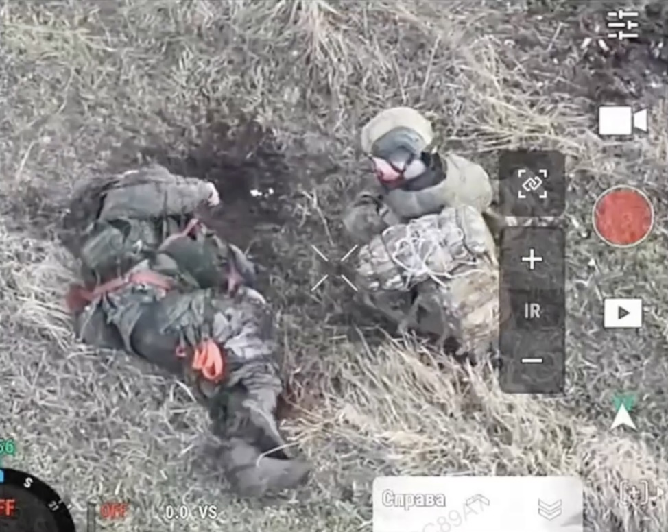 Two Russians are running around the tree dodging FPV, it hits anyway severely injuring one of them. While the other tries to help him, one more FPV hits close. The one who can still move around goes ahead and shoots his comrade in the face multiple times, then proceeds to shoot himself