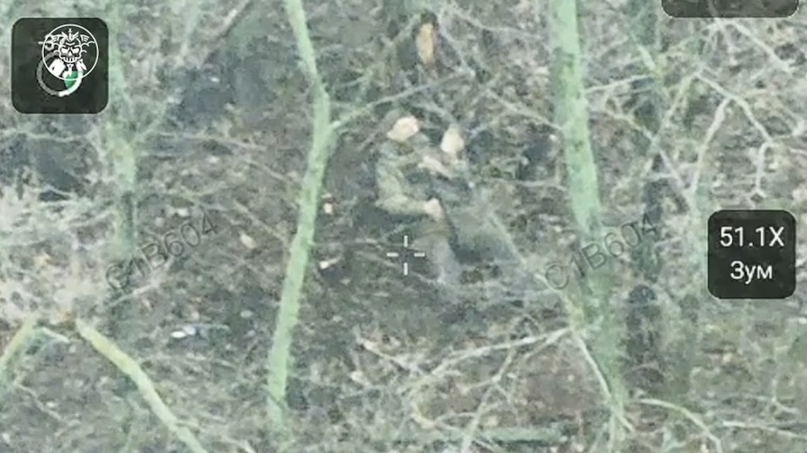 Russian is under FPV attack in a tree line, his leg is injured. He applies bandage to it then grabs his AK, makes quick test shot and shoots himself